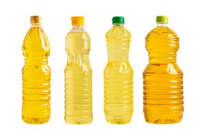 Vegetable oil in different bottle for cooking isolated on white background.